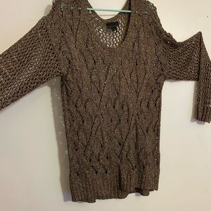 Knitted see through sweater with gold flakes.